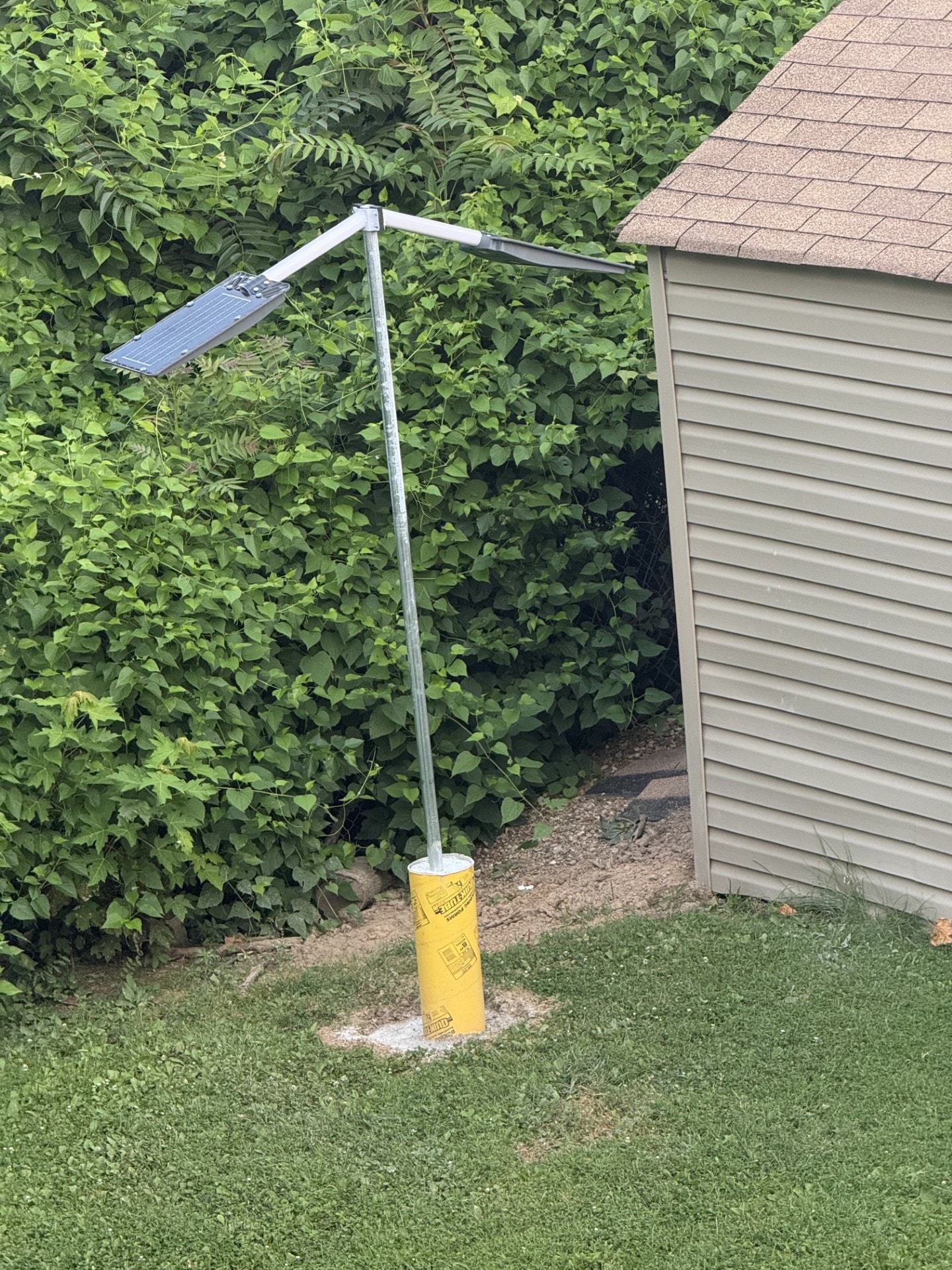 Home with solar panels and wind turbine for energy independence